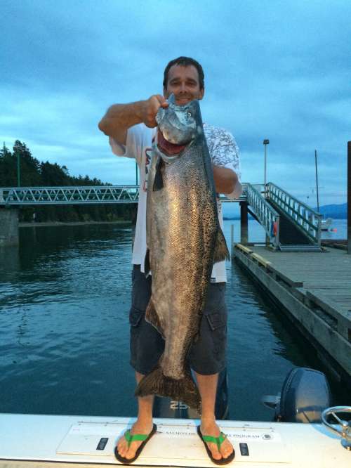 Proud angler with a beautiful 25-pound chinook salmon
