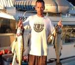 Captain Pat at the helm with a big smile